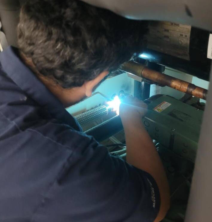 Compact Environmental Test Chamber with Yellow Trim A sleek, gray environmental test chamber with a yellow trim and front-facing control panel, designed for precise testing applications. The chamber features a windowed door for monitoring and is set against a blue gradient background.